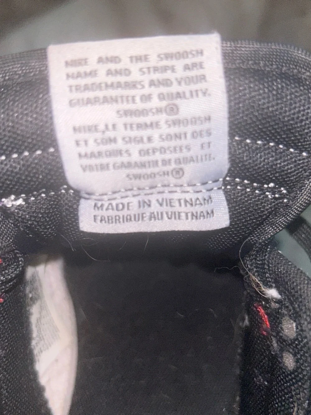 Nike Black and Red Athletic Sneaker Interior Label Visible